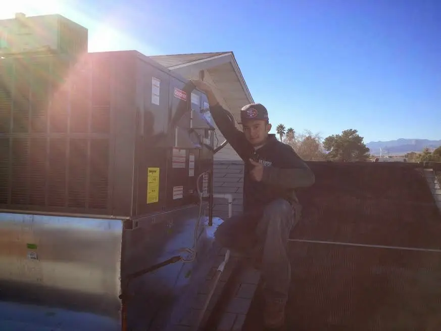 HVAC technician performing Boiler Repair on a rooftop unit in Oak Ridge